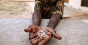 200462-an-illegal-diamond-dealer-from-zimbabwe-displays-diamonds-for-sale-in--687x357