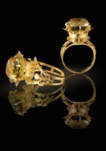 Gold ring with brilliants and gem on a black